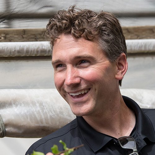 Jeff Stoven, Propagation Production Manager at Bailey Nurseries, smiles during a greenhouse visit.